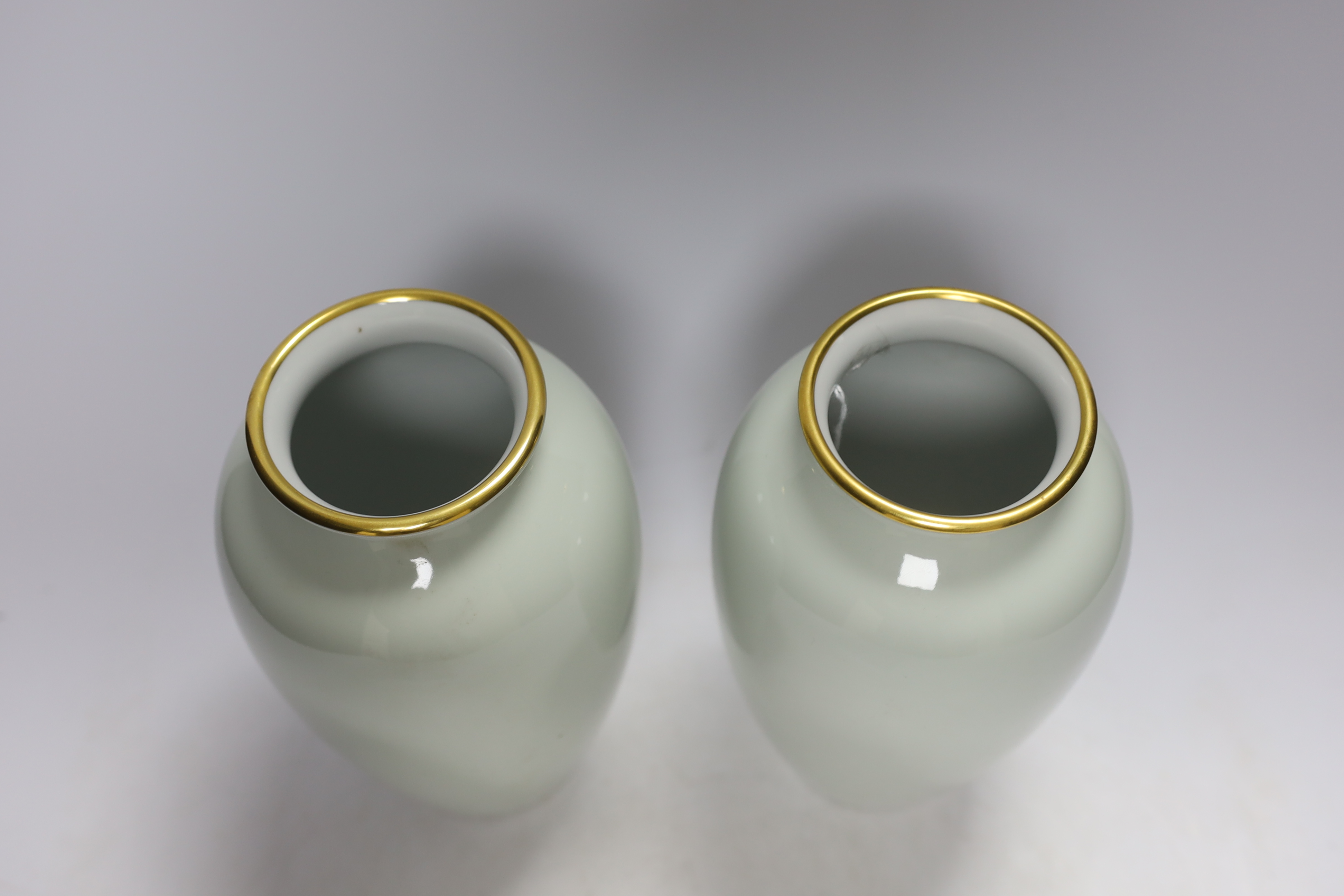 A pair of Japanese Fukagawa presentation vases, with Imperial sixteen petal chrysanthemum mon, probably a diplomatic gift, raised on hardwood stands, 25cm high